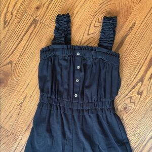 Black romper with button and ruffle details